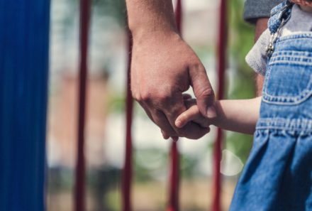 father holding daughters hand