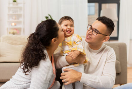 adoptive parents holding toddler