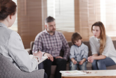 Pyschologist talking to adoptive family on a couch