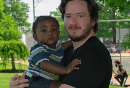 father holding baby